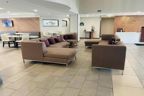 a waiting room with couches and tables in a hospital at Wingate by Wyndham Parkersburg-Vienna in Parkersburg