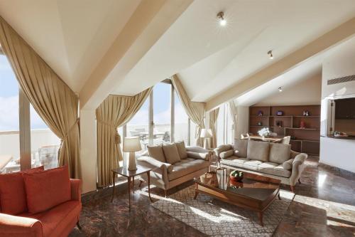 a living room with two couches and a table at Grand Hyatt Istanbul in Istanbul
