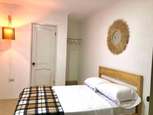 a bedroom with a bed and a clock on the wall at Sol Coral in Valdivia