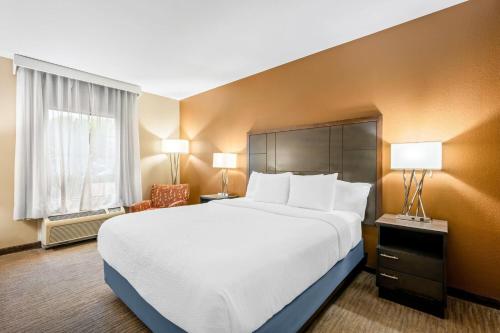 a hotel room with a large bed and a window at La Quinta by Wyndham Boone in Boone