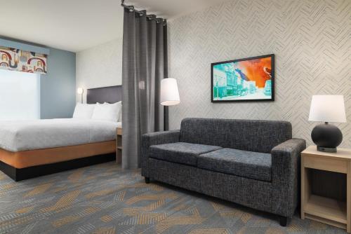 a hotel room with a bed and a couch at Home2 Suites By Hilton Cleveland, Tn in Cleveland