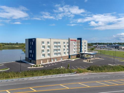 a large building with a parking lot next to a road at Hampton Inn & Suites By Hilton Port Clinton Catawba Island in Port Clinton