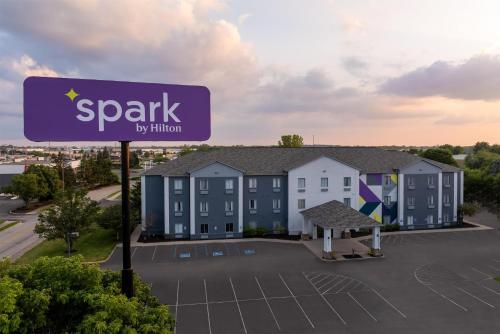 a sign in front of a building with a parking lot at Spark by Hilton Indianapolis Northeast Fishers in Fishers