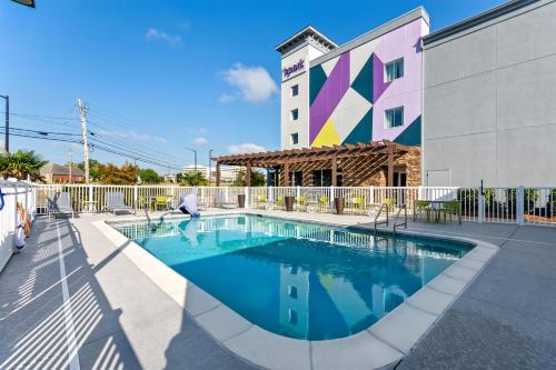 a swimming pool in front of a building at Spark by Hilton Dothan in Dothan