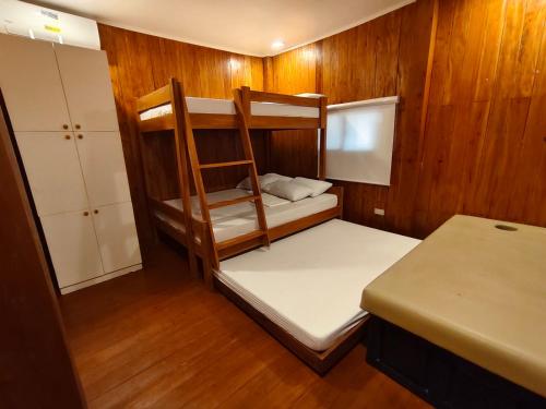 a small room with two bunk beds in a boat at J's PALM BEACH Resort in Batangas City