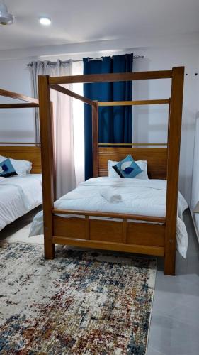 a bedroom with two bunk beds and a rug at Kathy's place in Nyali in Mombasa