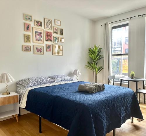 a bedroom with a bed with a blue blanket at The Marquee House in New York