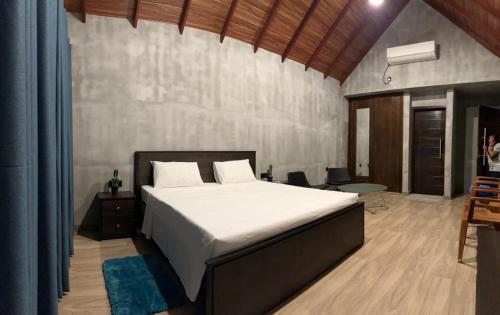 a bedroom with a large bed in a room at Lake Breeze Cabana Yala in Tissamaharama