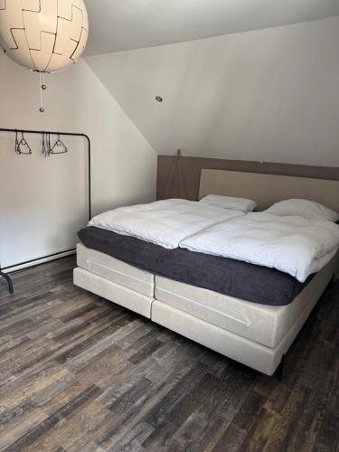 Cette chambre comprend un grand lit et du parquet. dans l'établissement Licata Trade fair accommodation - Messezimmer, à Düsseldorf