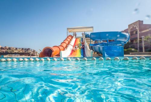a pool with a water slide in a resort at Sunny Days El Palacio Resort & Spa in Hurghada