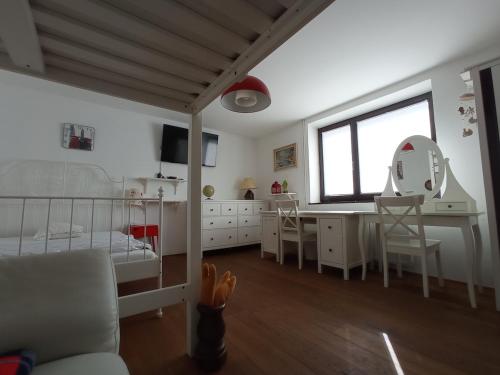 a bedroom with a bed and a desk and a mirror at Private house near Terme Čatež in Cerklje ob Krki
