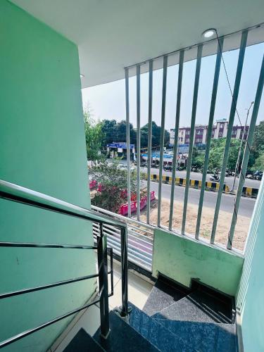 a balcony with a view of a parking lot at Delight Inn Guest House & PG in Lālewāl