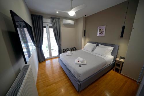 a bedroom with a bed with two towels on it at POSEIDON Executive Suite in Athens