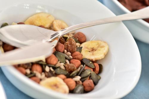 a bowl of nuts and seeds with a spoon at GT3 Hotel in Honerath