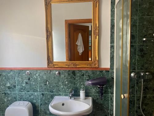 a bathroom with a sink and a mirror and a toilet at Tauriņkrasti in Bērzciems