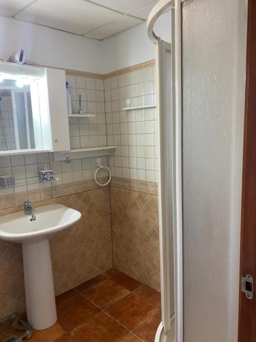 a bathroom with a sink and a shower at Beautiful apartment with gardens - sea and mountain views in Isla Plana