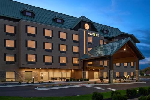 a hotel with a clock on the front of it at Home2 Suites By Hilton Frankenmuth in Frankenmuth