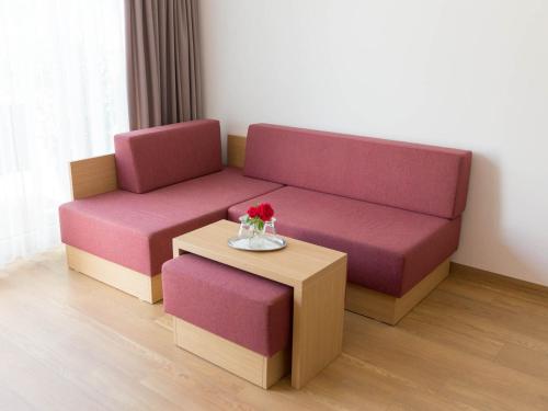 a living room with a couch and a table at Hotel Seepark Garni in Überlingen