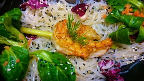 a plate of food with noodles and meat and vegetables at Romantik Hotel Villa Sayn in Bendorf