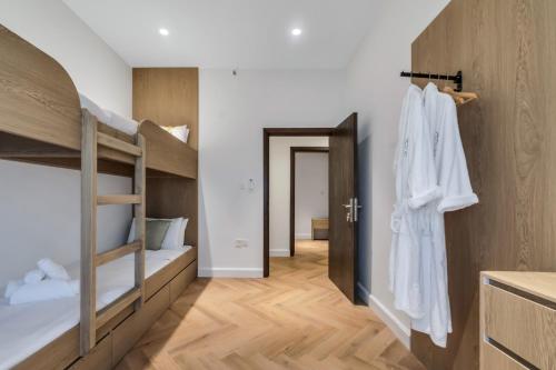 a room with bunk beds and a hallway at The Hideout, Khorfakkan in Khor Fakkan