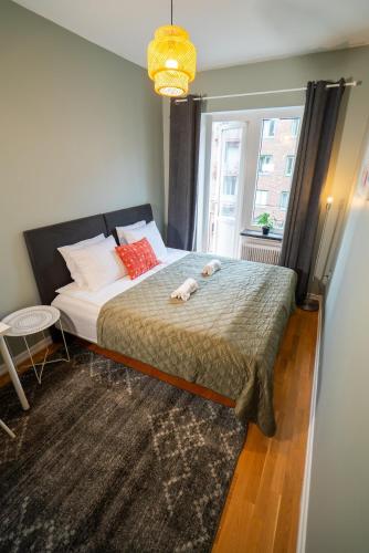 a bedroom with a bed with two dogs laying on it at Large Central 2BR - Scandinavian Design - Balcony in Gothenburg