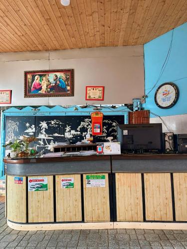 a food counter in a restaurant with a counter at Nhà Nghỉ Quỳnh Hương - Quynh Huong Hostel in Long Thành