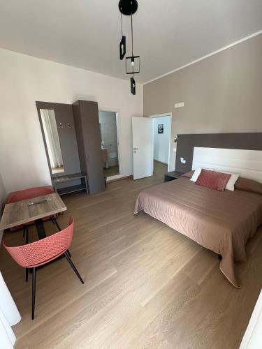 a bedroom with a bed and a table and a chair at Dreams29 in Cosenza