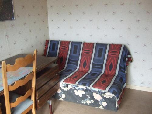 a bedroom with a bed and a table with a bedspread at Bij het station van Drongen in Ghent