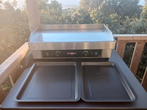 a stove top oven sitting on top of a balcony at U pino in Lumio
