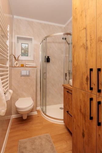 a bathroom with a shower and a toilet and a sink at Hygge Tiny House 1 - Berlin Brandenburg in Berlin