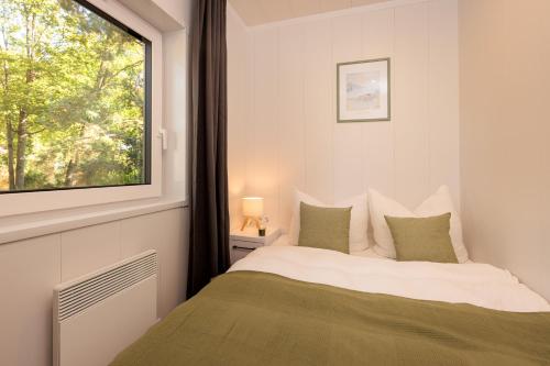 a bedroom with a bed and a window at Hygge Tiny House 1 - Berlin Brandenburg in Berlin