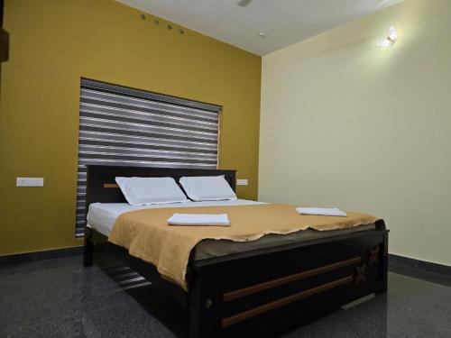 a bedroom with a large bed with two towels on it at Nature's Frame Residency in Varkala