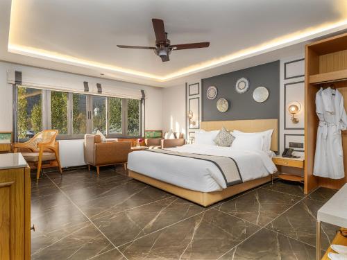 a bedroom with a bed and a living room at The Vale Lodge in Pahalgām