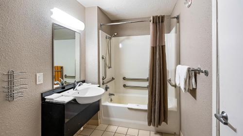 a bathroom with a sink and a shower and a tub at Motel 6-Kalispell, MT in Kalispell