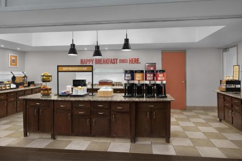 a large kitchen with a counter with bottles of wine at Hampton Inn & Suites Huntersville in Huntersville