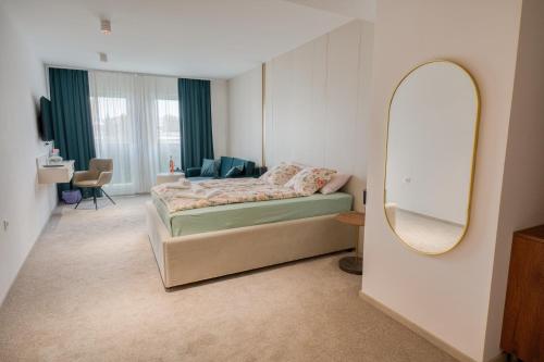 a bedroom with a bed and a mirror at Hotel Marina Home in Prijedor