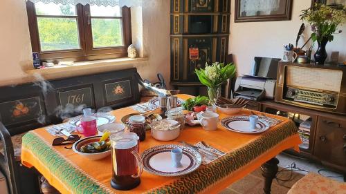 a table with plates and bowls of food on it at Na Żurawim Wzgórzu in Pasym