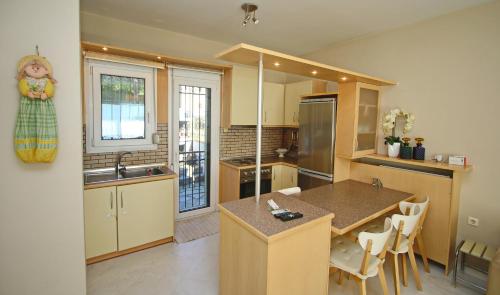 a kitchen with a sink and a counter top at Summer House Nea Peramos in Néa Péramos