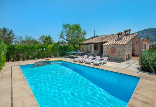 a swimming pool in front of a house at Owl Booking Villa Can Gorreta - 5 Min Walk To The Old Town in Pollença