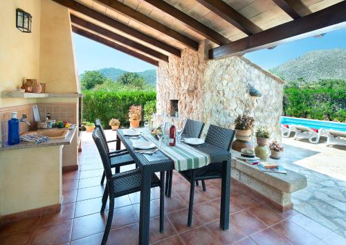 a kitchen and dining room with a table and chairs at Owl Booking Villa Can Gorreta - 5 Min Walk To The Old Town in Pollença