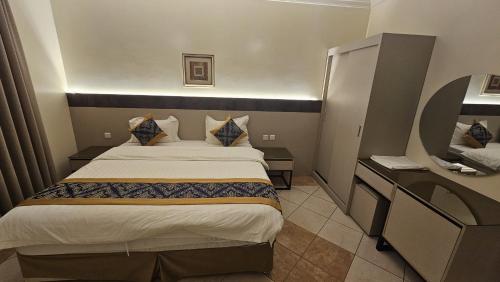 a hotel room with a bed and a desk at Lamar 1 furnished Aparthotel in Riyadh