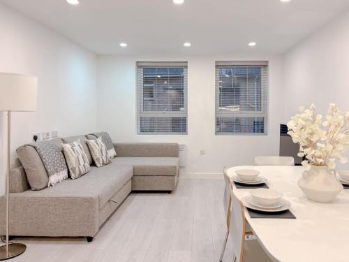 a living room with a couch and a table at St Faiths - City Centre Apartment in Norwich