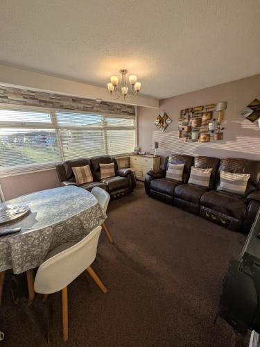 a living room with a couch and a table at 179, Two bed chalet on Sund0wner Holiday Park - Sleeps 4, free WiFi, sorry no pets - entertainment options close by in Hemsby