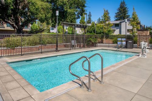 a swimming pool with a metal fence around it at Homewood Suites by Hilton Palo Alto in Palo Alto