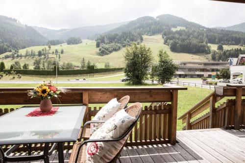 - une table et des chaises sur une terrasse avec vue sur les montagnes dans l'établissement Residence Mariagrazia, à Bad Kleinkirchheim