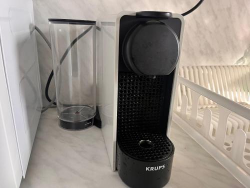 a black blender is sitting in a cabinet at St. Anastasia Apartments in Bansko
