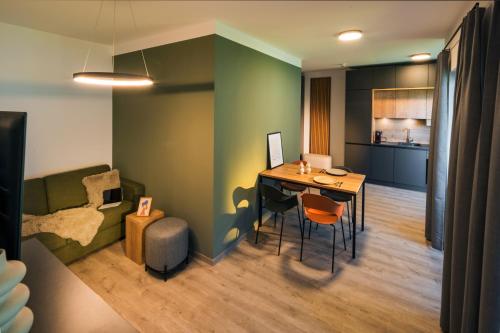 a living room with a table and a couch at Sattler Living Apartments in Ebbs