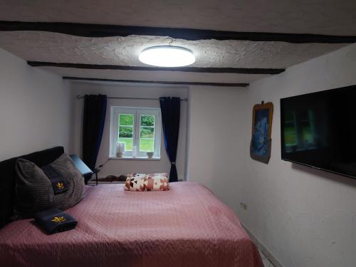 a bedroom with a bed with a stuffed animal on it at Appartment Schlossmühle in Olsberg in Olsberg