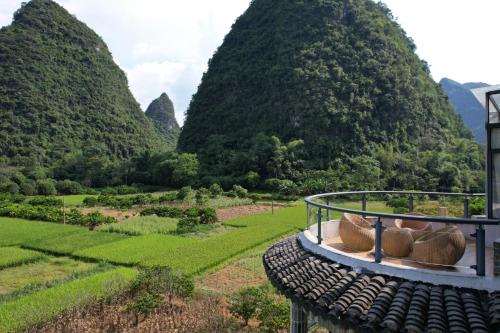 a view of a valley with mountains in the background at Qingshan Yuandai Boutique Homestay Yangshuo in Yangshuo
