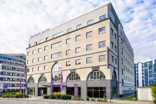 a large white building with a sign on it at Mercure Hotel Frankfurt Eschborn Süd in Eschborn